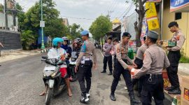Personel Polres Jepara, saat bagikan takjil kepada masyarakat pengendara di jalan.
