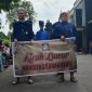 Kegiatan buka Luwur Sunan Kedu (Seikh Abdul Bashir) di desa Gribig, Kec. Gebog, Kab. Kudus. Tampak peserta kirab membentangkan spanduk kegiatan.