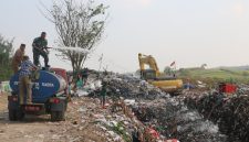 Prajurit Kodim Pati saat menyemprotkan cairan mikroba ke tumpukan sampah.