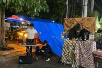 Mahasiswa ilmu komunikasi USM saat memainkan musik DJ. Nampak warung jamu berdampingan dengan angkringan, menambah suasana klasik kekinian.
